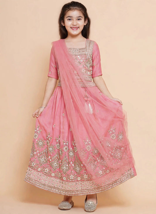Girls pink embroidered lehenga with sheer pink dupatta draped over shoulder