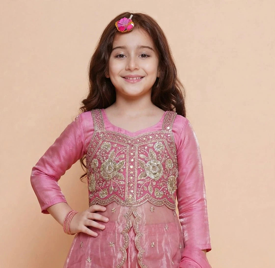 Girl twirling in dusty pink embroidered palazzo set with flowing scalloped overlay