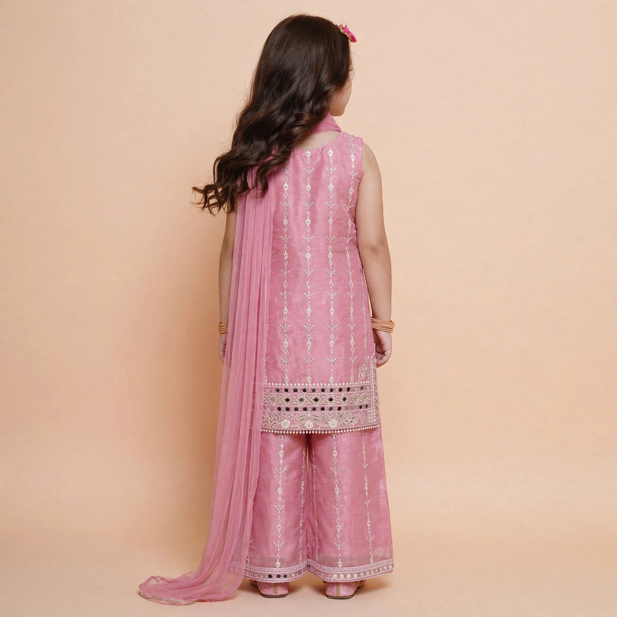 Back view of girls pink embroidered kurta palazzo set with mirror-work hem borders and dupatta