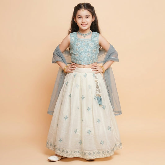 Side view of girls teal sleeveless choli and ivory floral lehenga