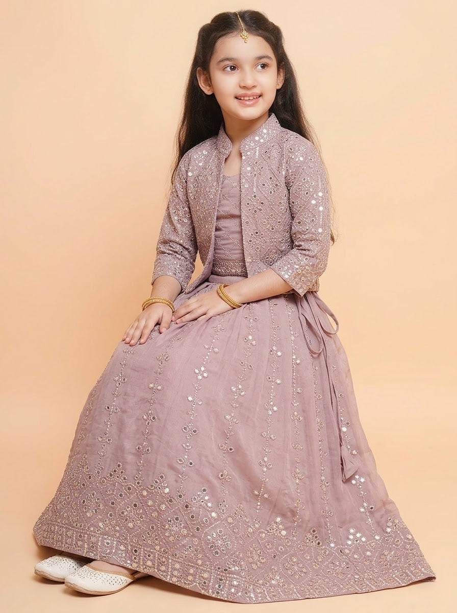 Close-up of mauve embellished jacket and diamond-pattern choli