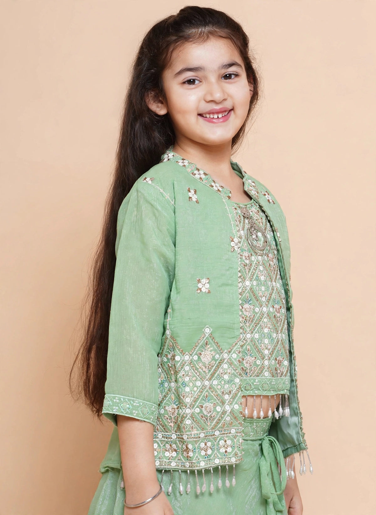 Girls pista green lehenga choli with embroidered jacket and pearl-drop fringe