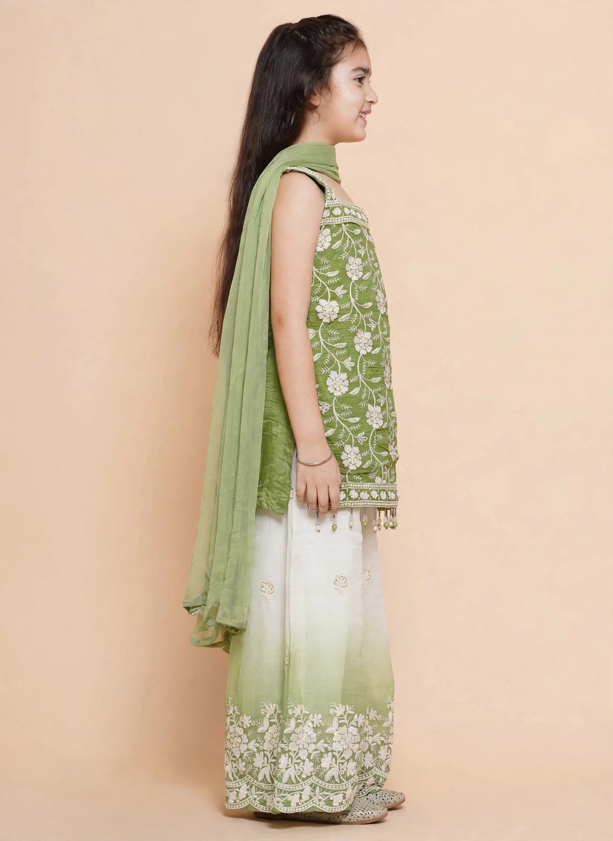 Girls green kurti palazzo set showing sheer sleeves and scalloped embroidered pant hems