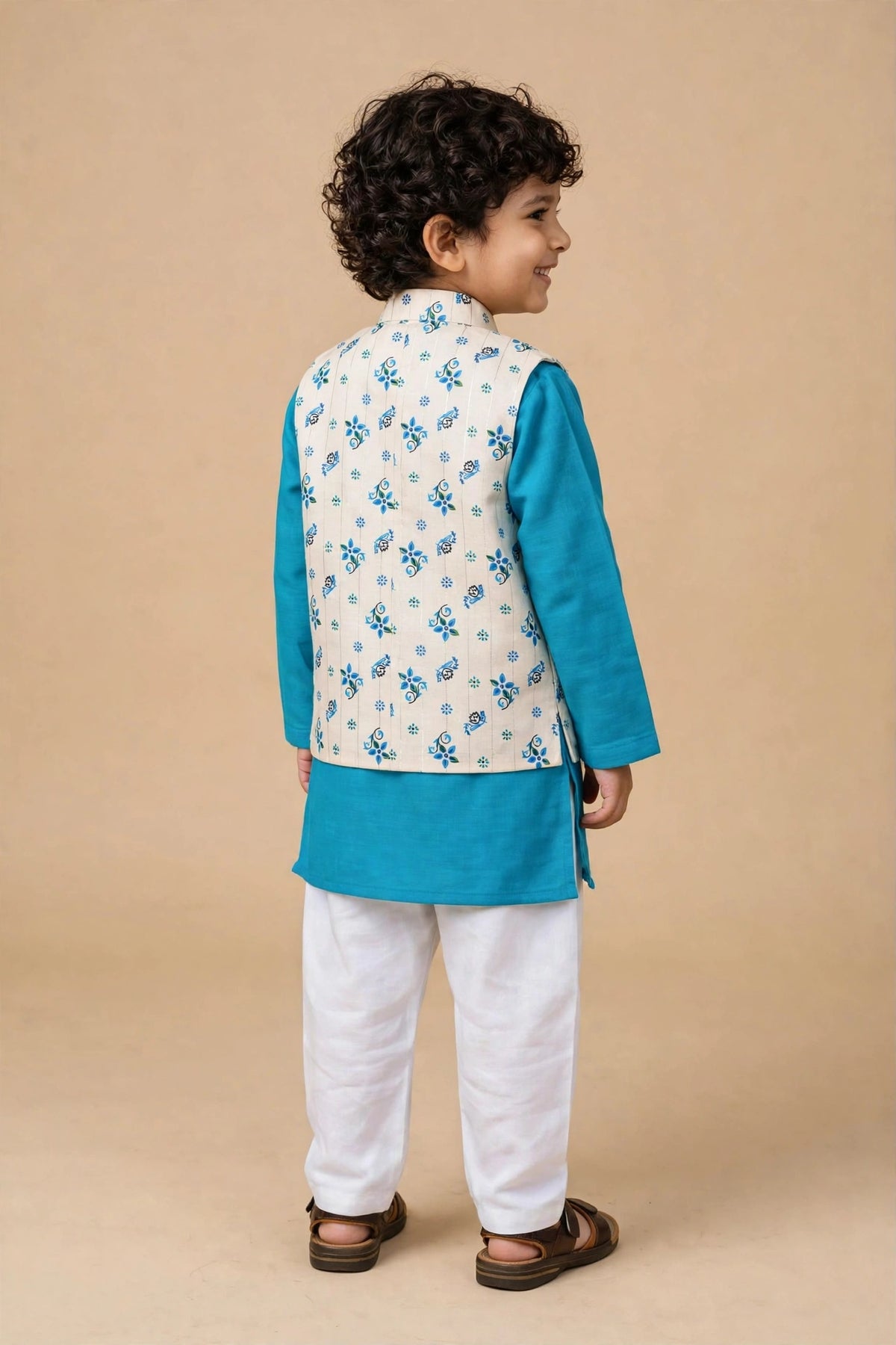 Front view of boys turquoise kurta pyjama set with cream blue floral Nehru jacket