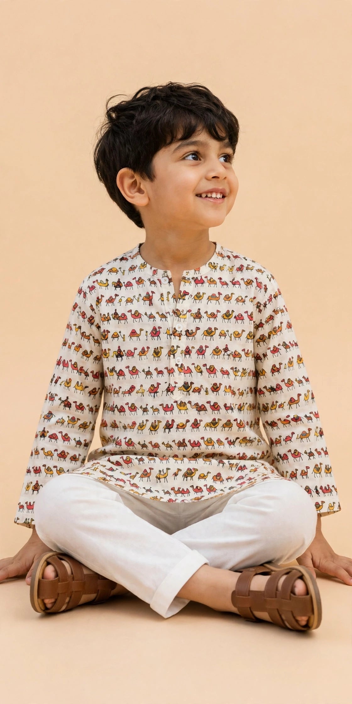 Side view of boys cream camel print kurta with white pajama