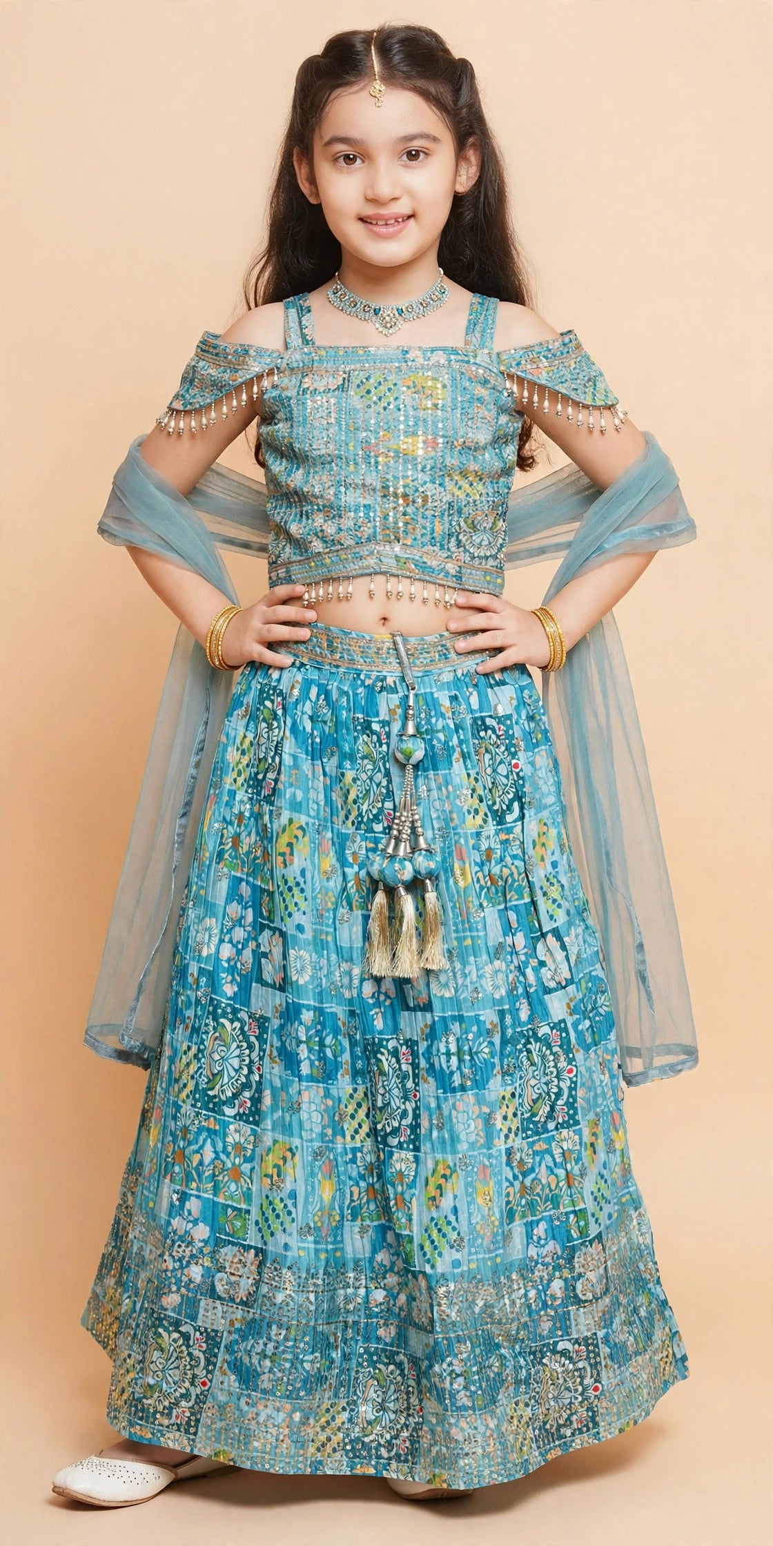 Back view of sky blue patchwork lehenga set showing tie bow and gold tassels
