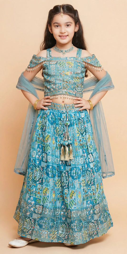 Back view of sky blue patchwork lehenga set showing tie bow and gold tassels