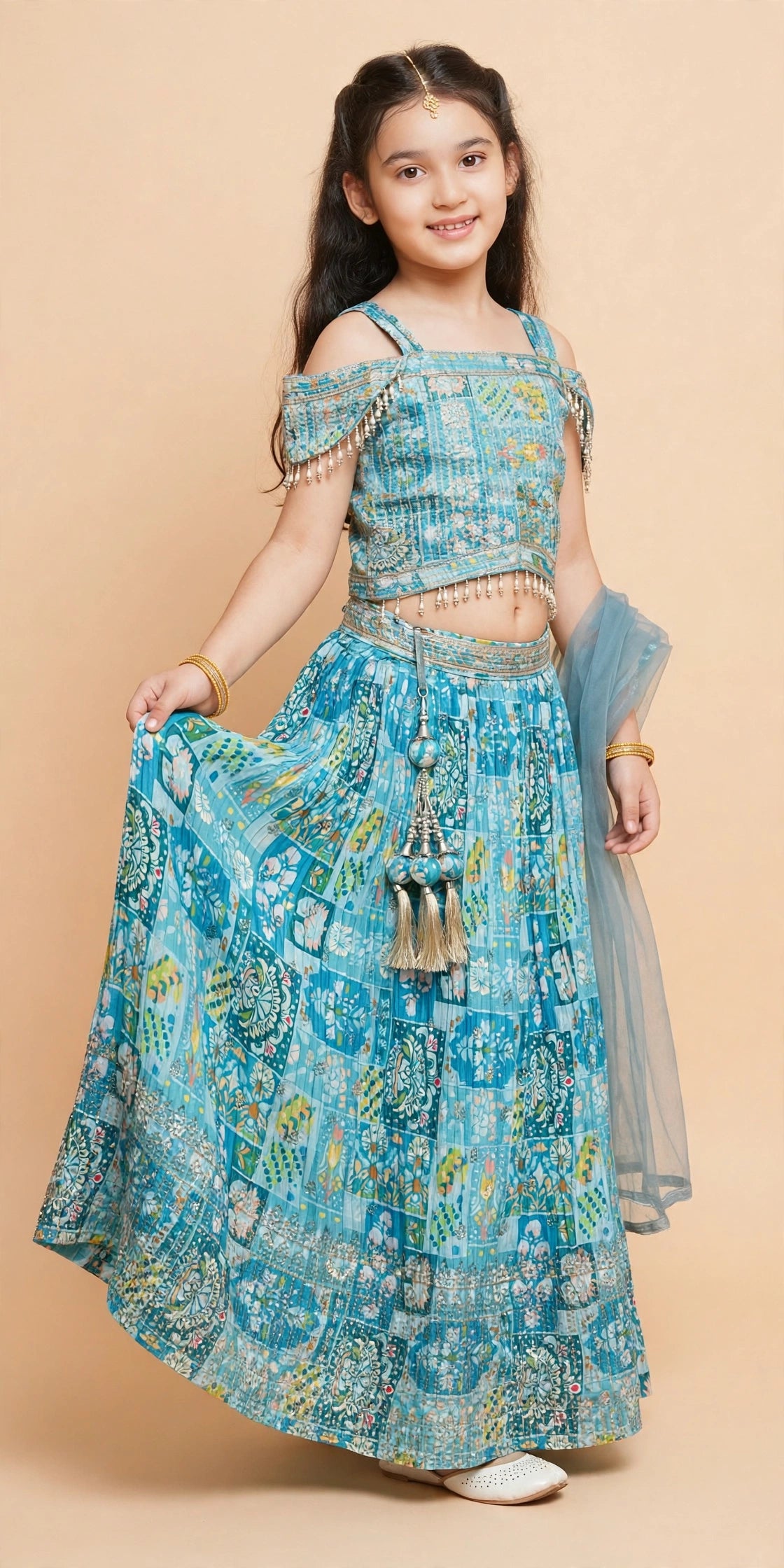 Sky blue printed lehenga choli showing pearl fringe and decorative waist latkan