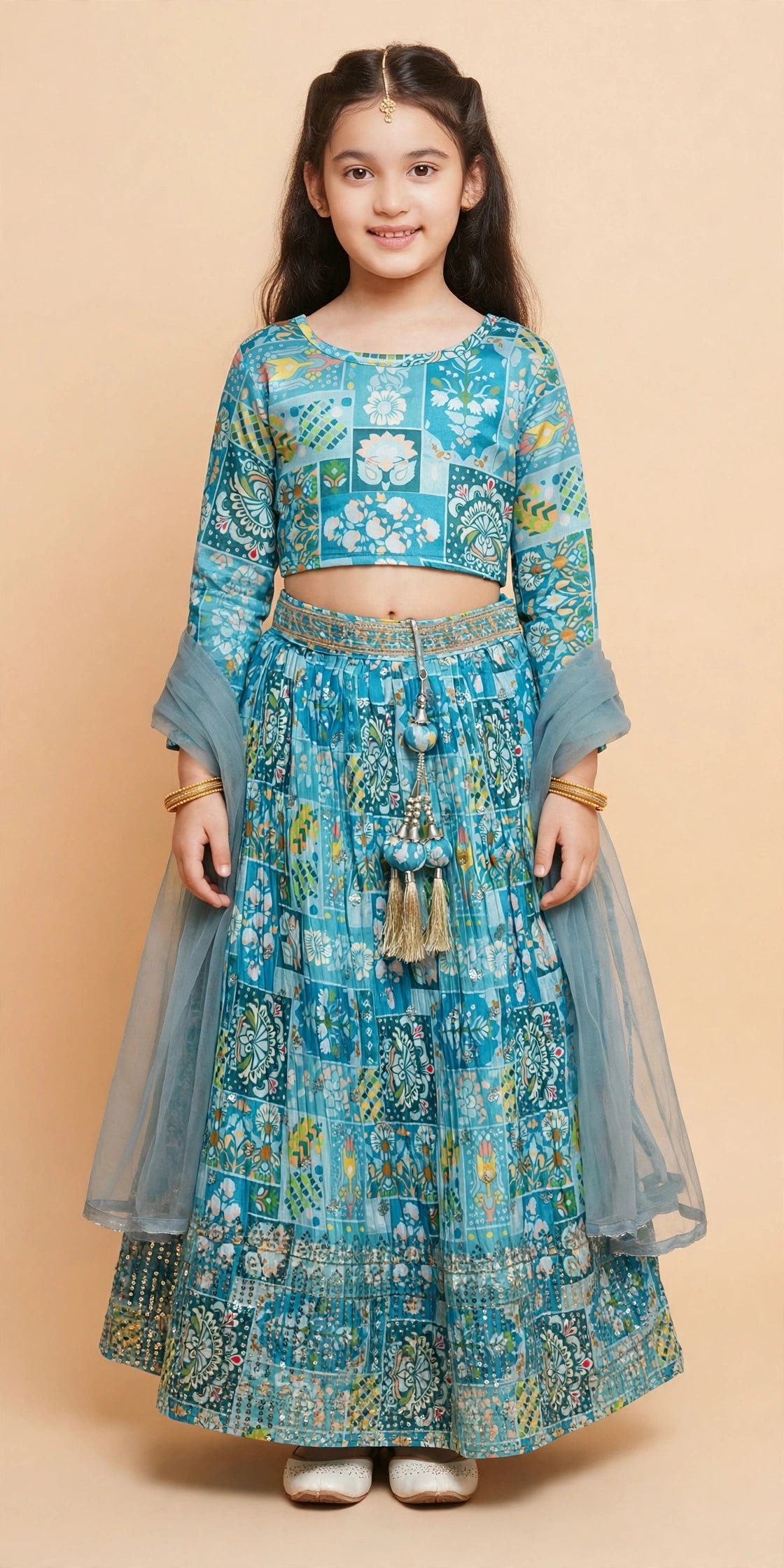 Girl twirling in sky blue patchwork print lehenga with sequin border