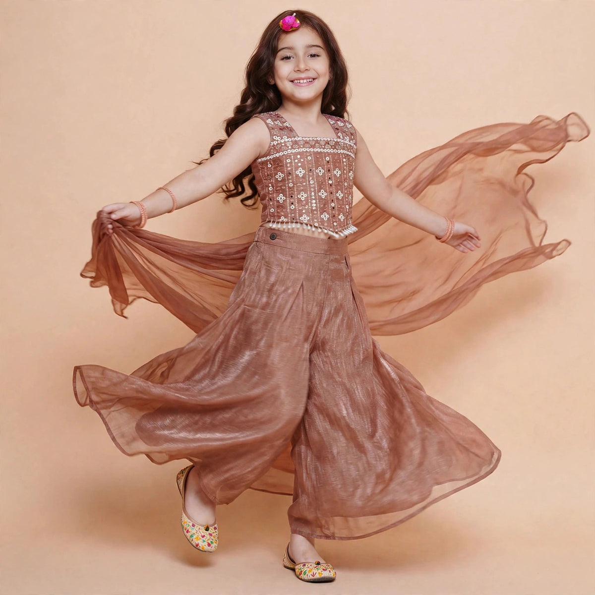 Girls copper brown palazzo set in motion showing flowing wide-leg pants and sheer dupatta