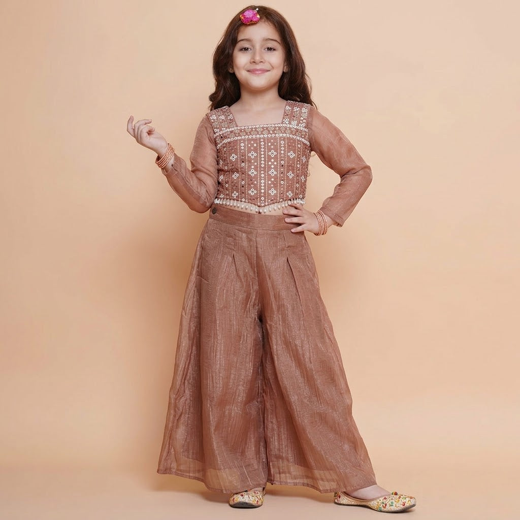 Front view of girls copper brown embroidered choli and wide-leg palazzo set with sheer long-sleeve inner top