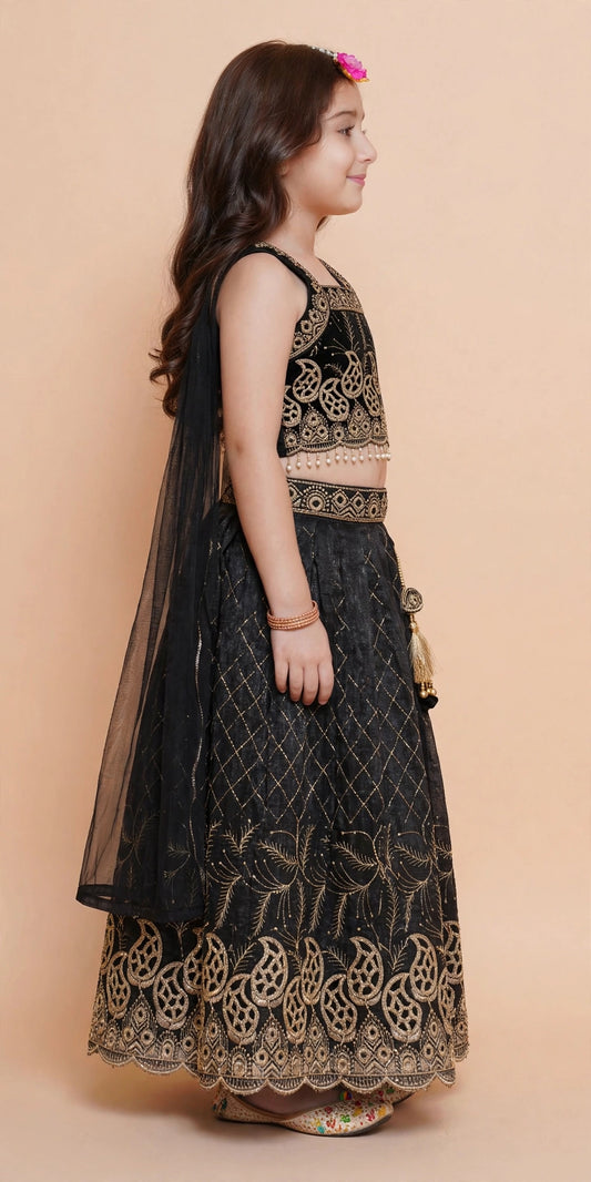Side view of girls black lehenga choli with gold paisley embroidery and sheer dupatta