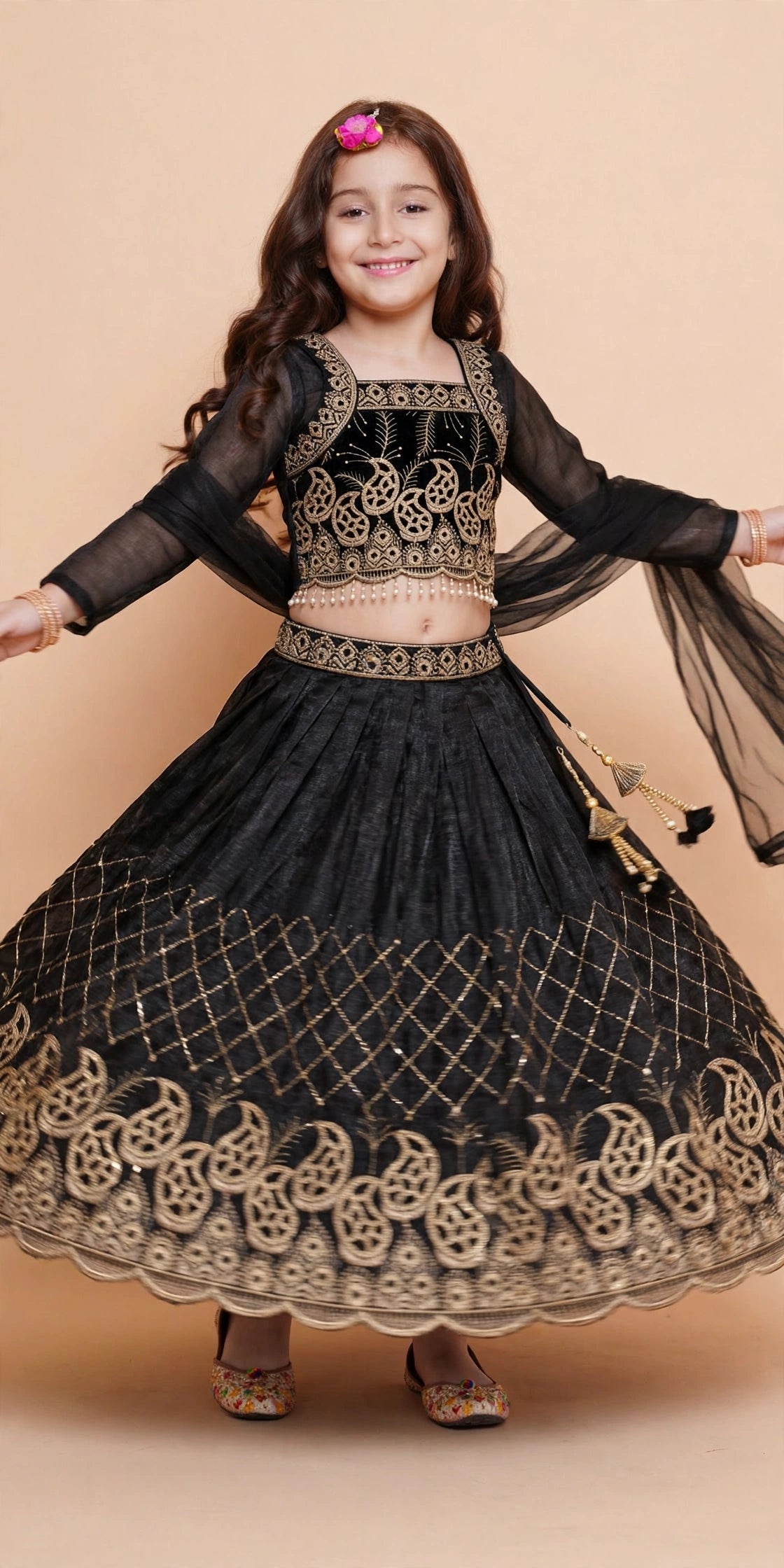 Girls black and gold embroidered lehenga skirt flaring while twirling