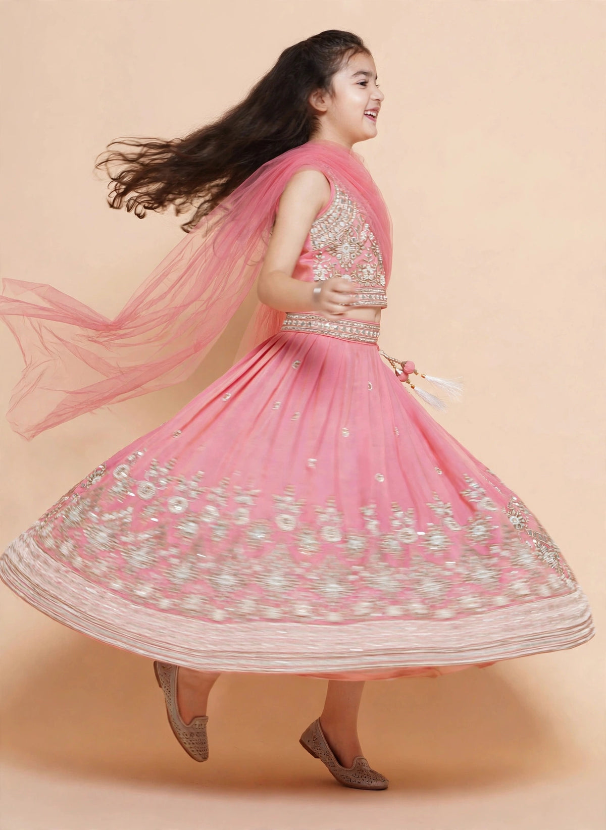 Girls pink embroidered lehenga choli shown with sleeves and draped dupatta