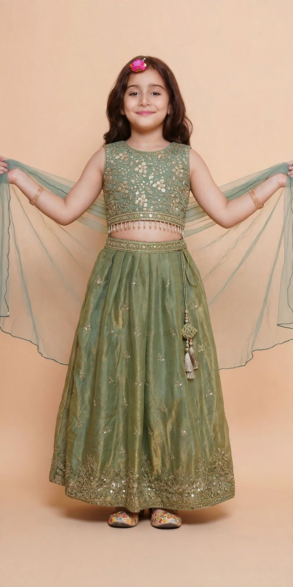 Side view of full-sleeve sage green choli and gold embroidered lehenga