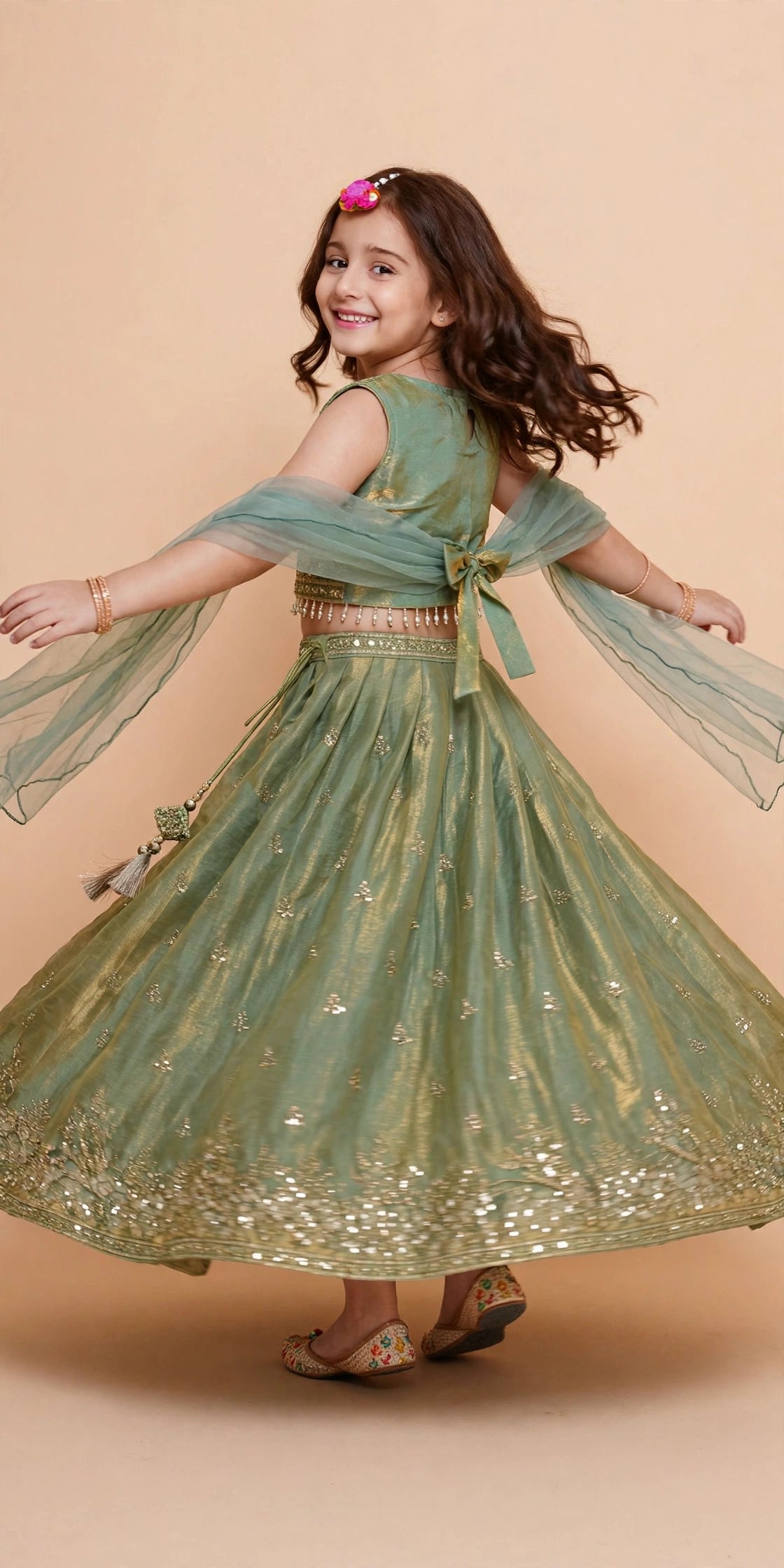 Back view of girls sage green lehenga with statement bow