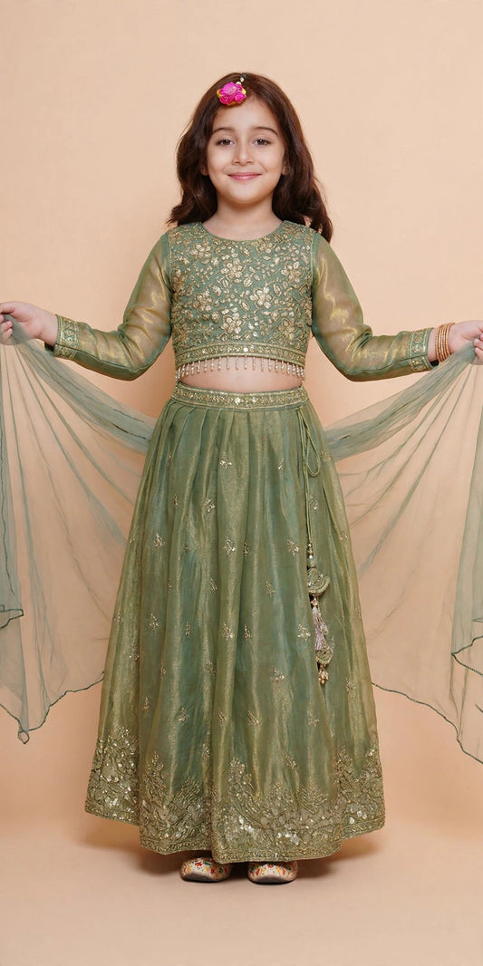 Side view of sage green lehenga showing bow-back choli and tassel tie