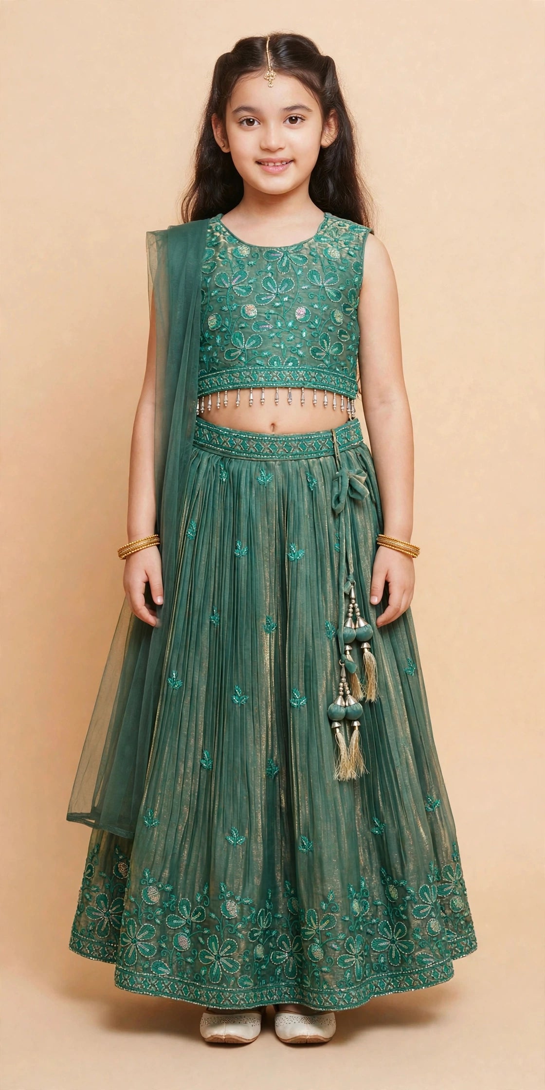 Front view of girls deep green embroidered lehenga choli with pleated skirt, tassel latkan and sheer dupatta