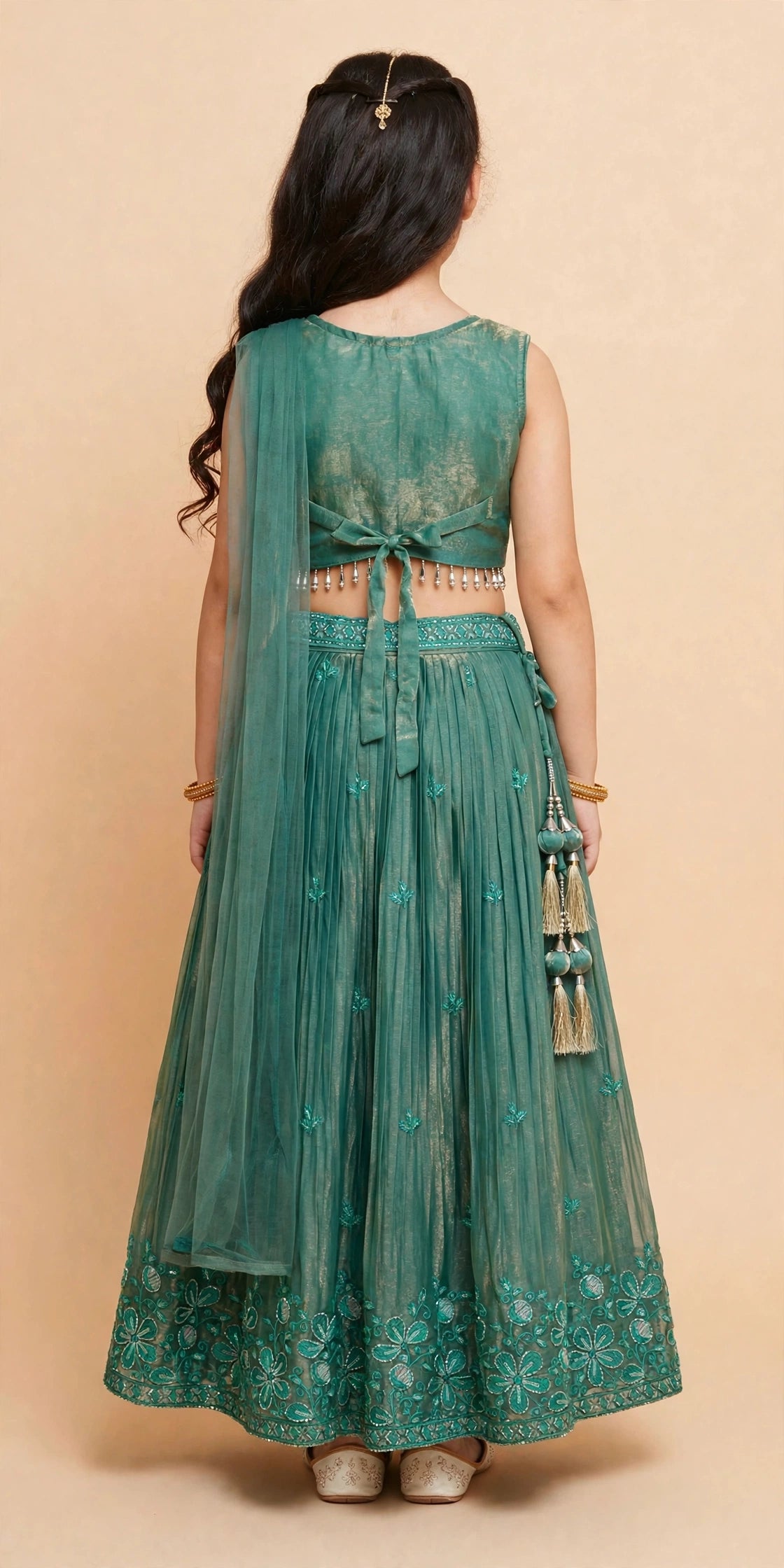 Back view of deep green lehenga choli showing plain tie-up choli back and flowing dupatta